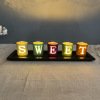 Black wooden creative set with letters, candle, decorations, jewelry