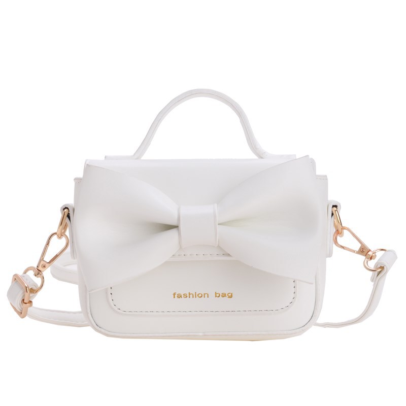 2025 nuevo bolso para niños mini accesorios para niños bolsos de mano simple color sólido arco extranjero bolso de hombro para niñas
