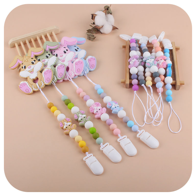 Amazon nuevo bebé suministros de dibujos animados conejo de silicona juguete mordedor pezón anti-gota cadena molar traje