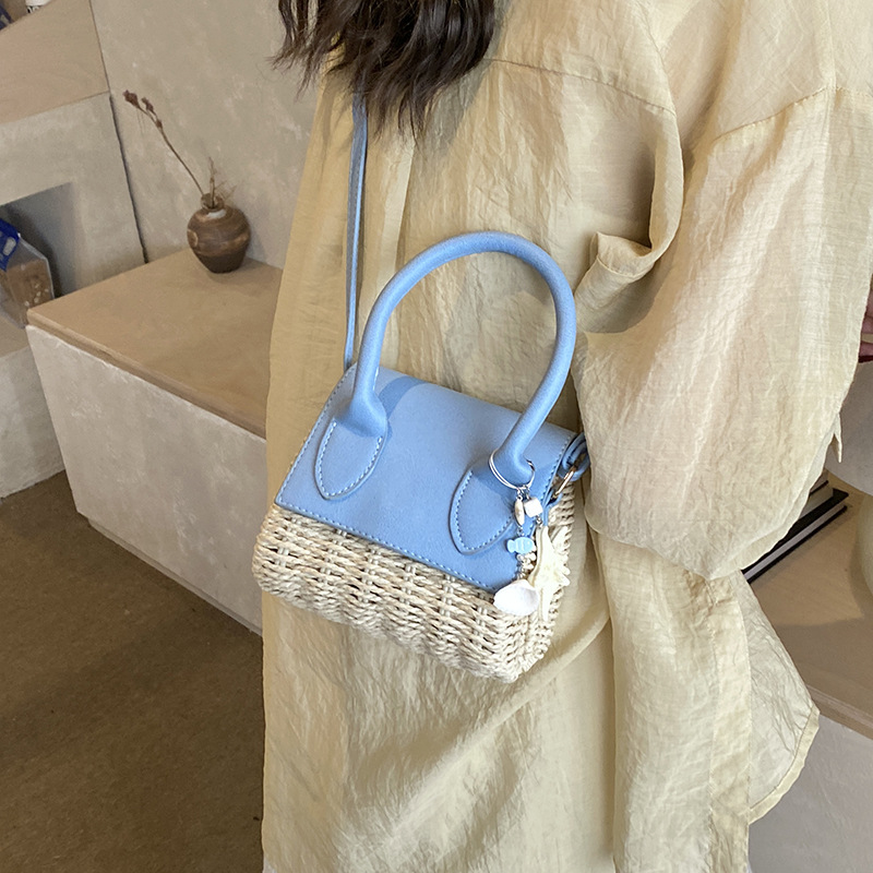 Mini bolso nuevo verano 2026 tela de paja de moda nicho sensación diaria bolso de hombro bolso de mochila