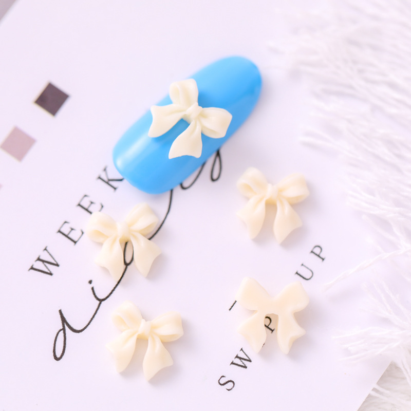 Mariposa de uñas popular repujado arco resina pajarita joyería simple todo partido tridimensional hueco decorativo diamante