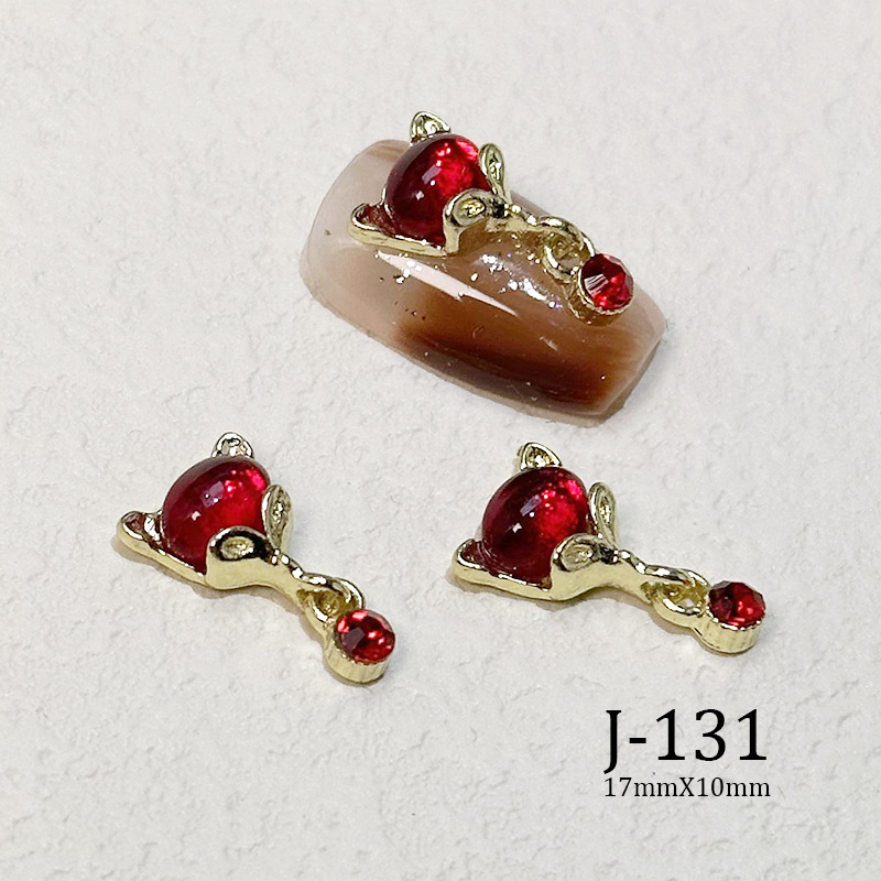 2023 Nueva joyería de uñas Año nuevo rojo aleación conejo rojo mariposa de cristal pintura en aerosol arco accesorios de diamantes de uñas