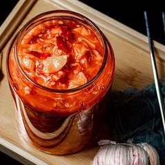 Kimchi, the authentic Korean spicy cabbage, is a perfect side dish for a homely Korean meal. It's a traditional Korean fermented vegetable dish, usually made from cabbage and chili pepper flakes. The spicy and sour taste of kimchi makes it a popular choice for accompanying Korean meals. It's a staple in Korean cuisine and is enjoyed by many as a flavorful side dish.