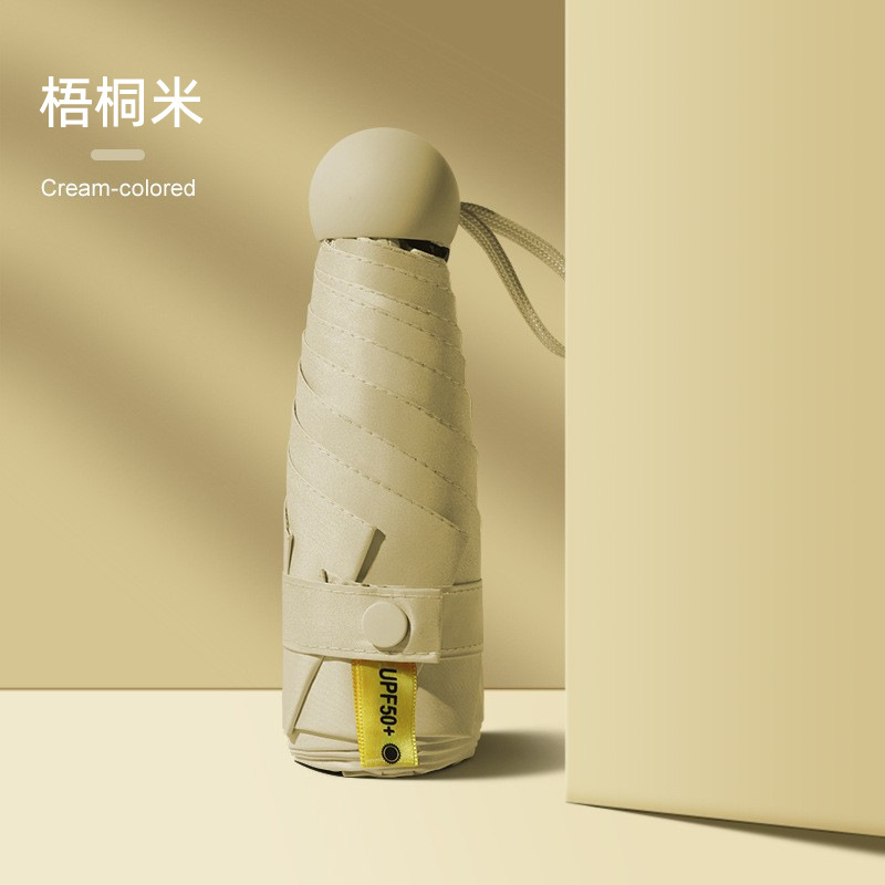 50% de descuento paraguas de cápsula de seis huesos paraguas de Sol de doble uso pequeño paraguas de bolsillo portátil simple pegamento negro paraguas de protección solar al por mayor