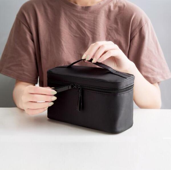Capacious handheld cosmetic bag