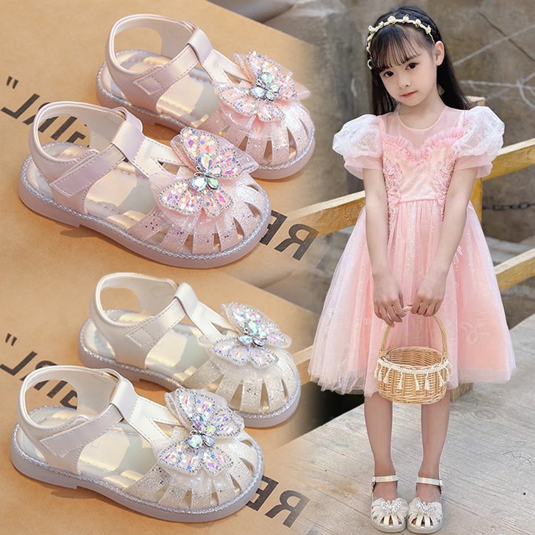 Niñas sandalias Baotou 2026 verano nuevo arco de moda zapatos de suela suave zapatillas de princesa casuales niños
