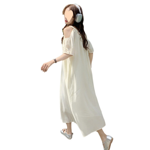 Elevated maternity dress for summer: chic, laid-back design with delicate cutouts and an off-shoulder neckline—perfect for a stylish, mid-length summer look.