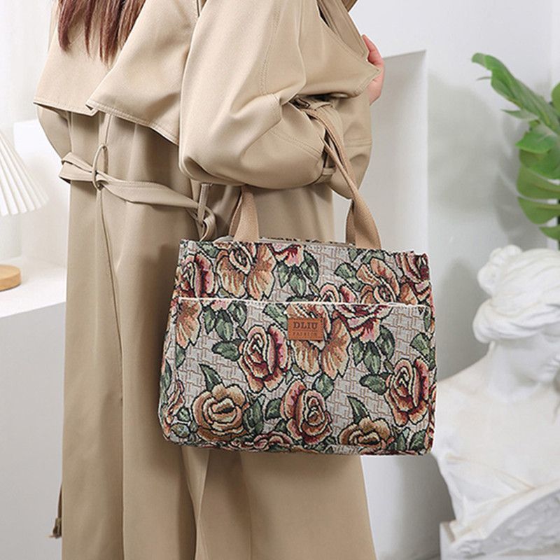 This retro handbag features a tote flower oil painting style. It's convenient to carry a lunch box to work. It has a large capacity and is a mommy bag for going out undefined