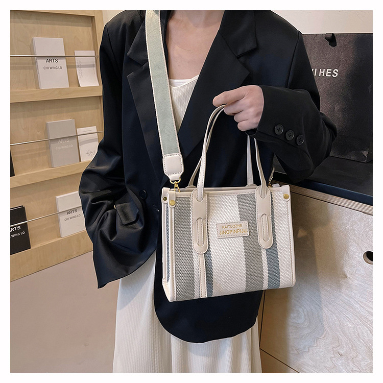 Bolso Tote portátil a rayas de color de contraste de lona para mujer 2024 nueva textura de moda transfronteriza bolso de mensajero de un solo hombro