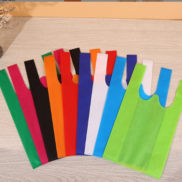 Bolsas de tela no tejida en stock bolsas de compras bolsas de chaleco impresión en color logotipo y patrón publicitario bolsas ecológicas