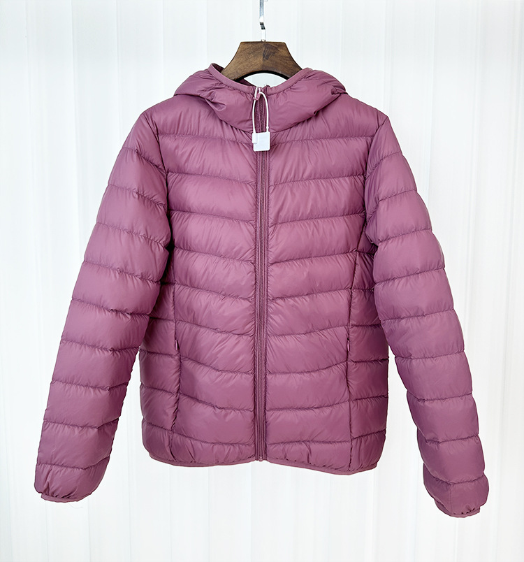 Chaqueta de plumón ligera para mujeres otoño y invierno 2025 nueva chaqueta de plumón de costillas con capuchón corto conveniente para almacenar chaqueta pequeña