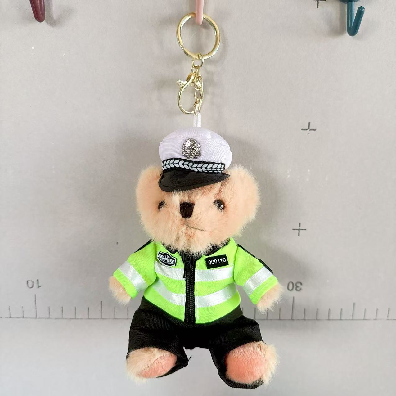 Políticas de tráfico en línea juguetes de peluche muñecas de agua de oso colgante bolso colgante llavero 4 pulgadas muñecas agarrar