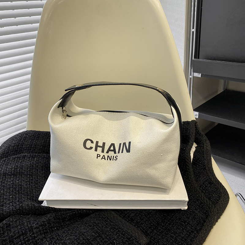 Bolsa de maquillaje de lona simple, nuevo estilo de aire extranjero, bolsa de mano de gran capacidad de almacenamiento, bolsa de almacenamiento simple para viajes