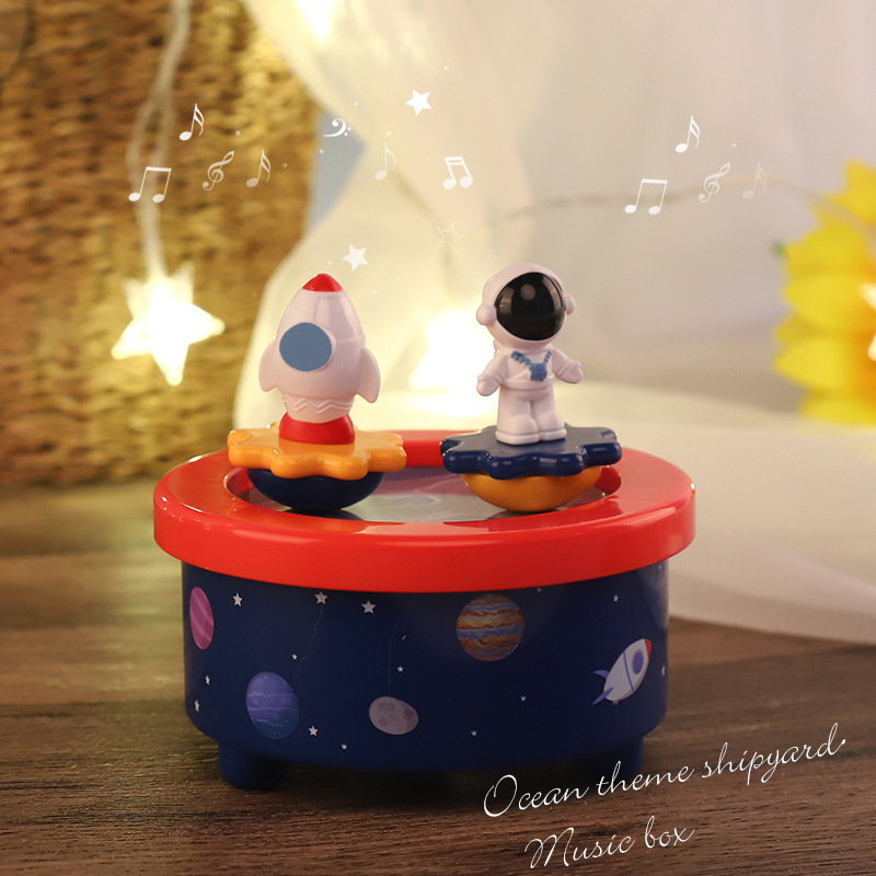 Base naval de dibujos animados amazonos niños caja de música pianos astronautas girando planetas explorando cajas de octeto