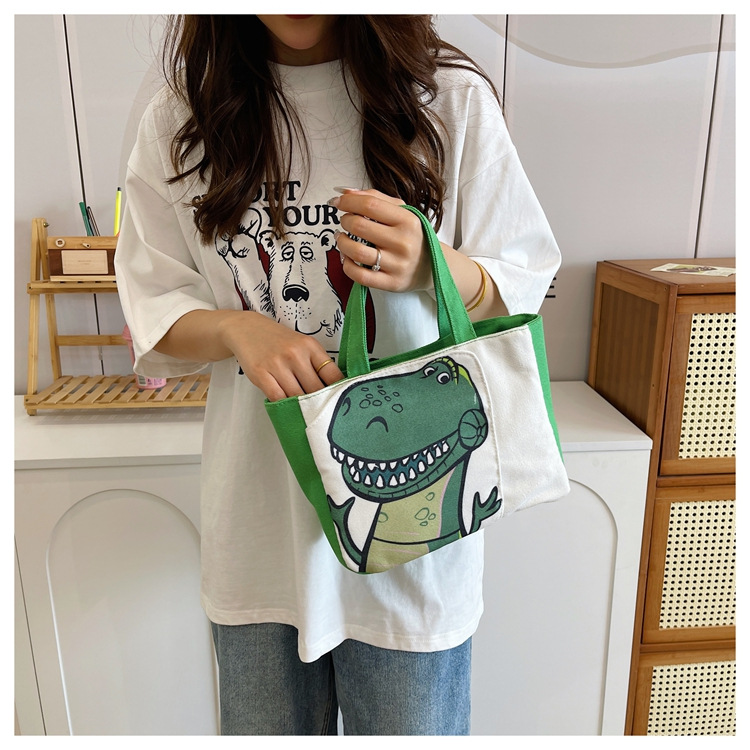 Cute cartoon printed small bag, 2024 summer new style hand-held piggy girl handbag, student storage canvas bag undefined