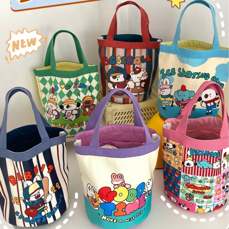 かわいい落書きバケツバッグinsプリント円筒バッグキャンバス弁当袋韓風少女は弁当箱を持っています。|undefined
