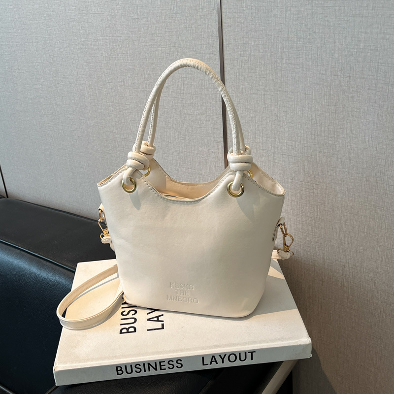 2025 nuevo bolso pequeño de estilo occidental simple y popular bolso de mensajero de moda de verano femenino bolso de cubo portátil casual