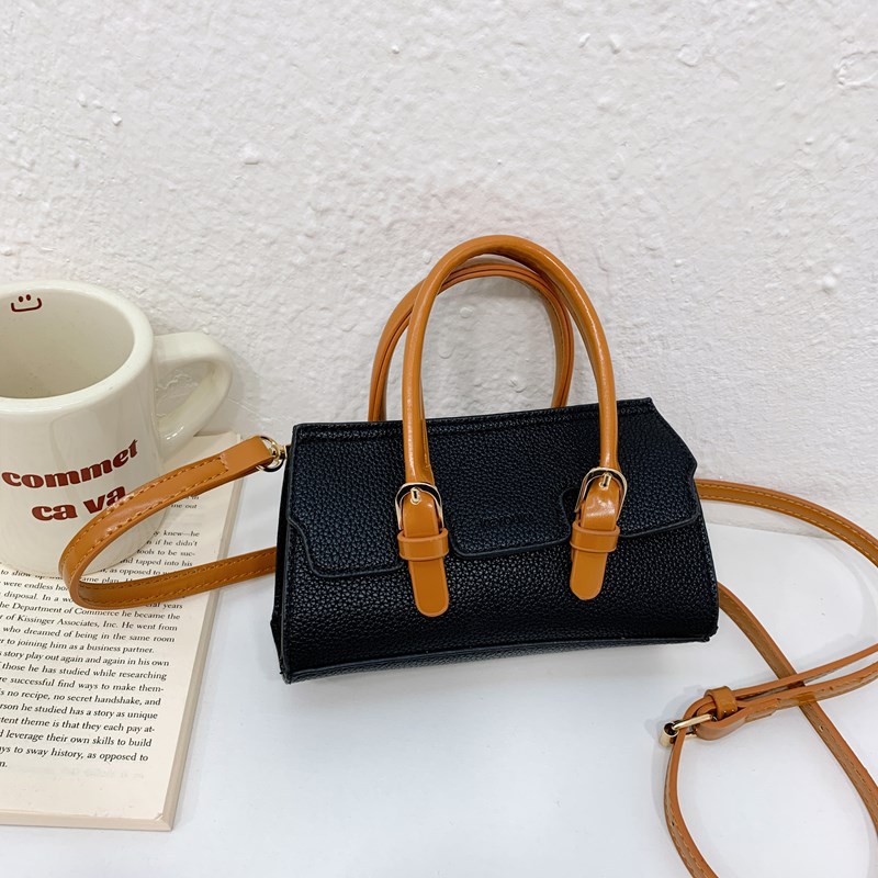 2025 nuevo bolso para niños de comercio exterior, bolso de niña popular de moda coreana, bolso de mensajero para bebé de color sólido de estilo extranjero