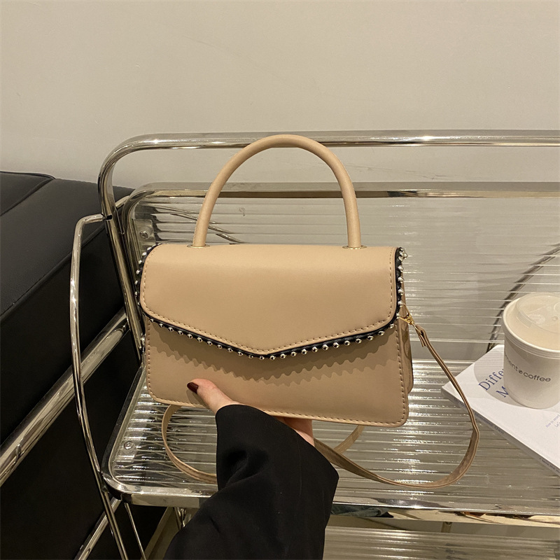 Bolso de hombro de aire extranjero para mujeres 2025 primavera nueva moda coreana portátil de color sólido simple bolso de tendencia