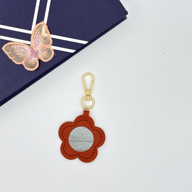 Flor espejo llavero cuero transfronterizo regalo colgante joyería creativo mini lápiz labial almacenamiento llavero colgante
