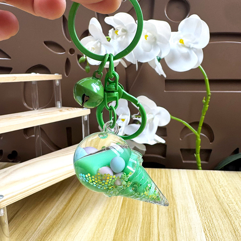Caricatura en aceite líquido arena flotante botella mochila llavero delicado colgante accesorios accesorios máquina de muñecas pequeños regalos al por mayor