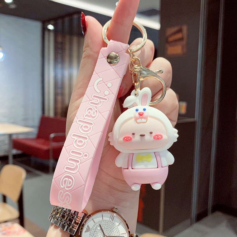 Muñeca de goma goteando bolsas escolares colgantes colgantes de muñecas colgantes de la máquina del mercado nocturno regalos al por mayor llaveros de dibujos animados