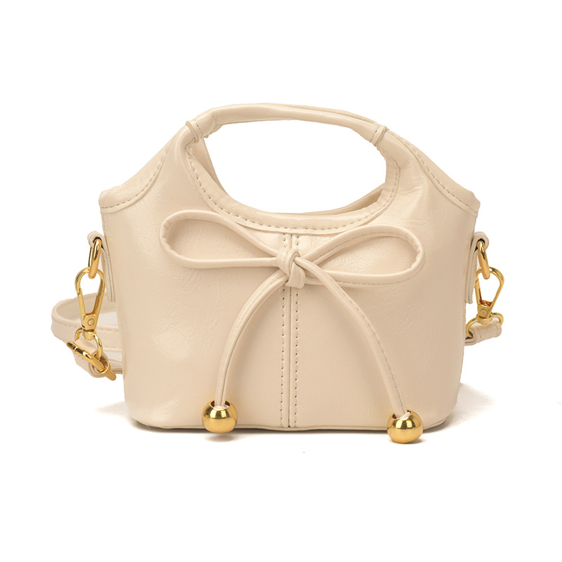 Bolsas infantiles transfronterizas de moda coreana de color sólido, bolsas de mano de chicas, mini bolsas de cestas de arco lindas