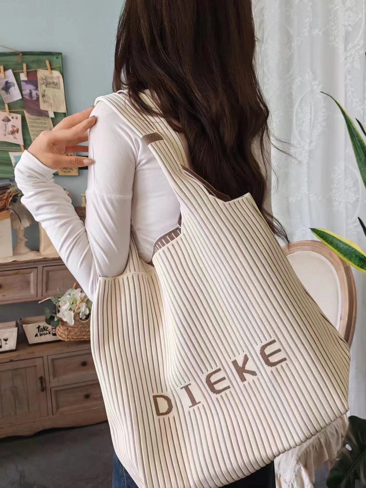 The new large-capacity fly-woven bag with louvers and letters is a portable and fashionable handbag that can be worn on one shoulder undefined