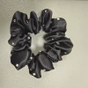 Black perm hair tie feels slightly sticky but does not affect use