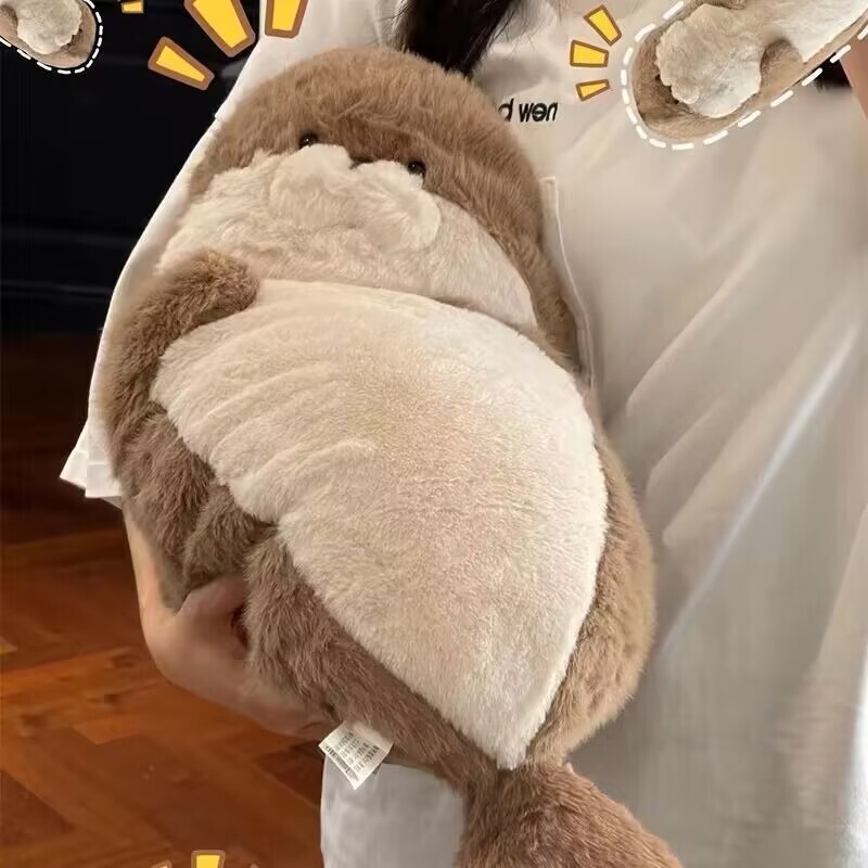 かわいいアザラシのぬいぐるみのぬいぐるみのベッドの上で寝ています。|undefined