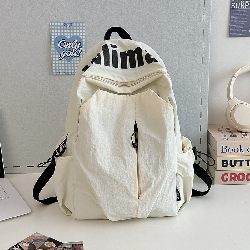 Mochila escolar 2025 nicho ligero y anti-salpicaduras de agua estudiantes de secundaria hombres y mujeres deportes de gran capacidad al aire libre mochila de viaje