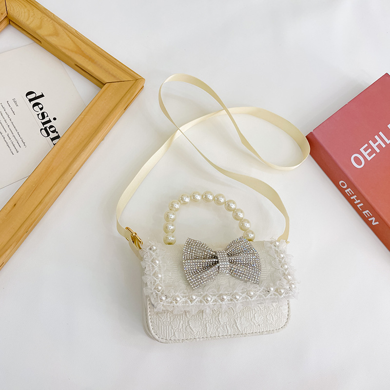 Bolsa de Niños de estilo coreano lindo arco perla Bolso pequeño princesa estilo occidental desgaste a juego joyería bolsa crossbody bolsa