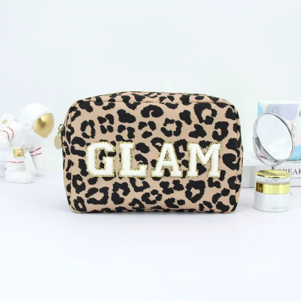 Leopard-print suede cosmetic bag with fashionable letter embroidery, large capacity, portable travel organizer, and stylish handheld design