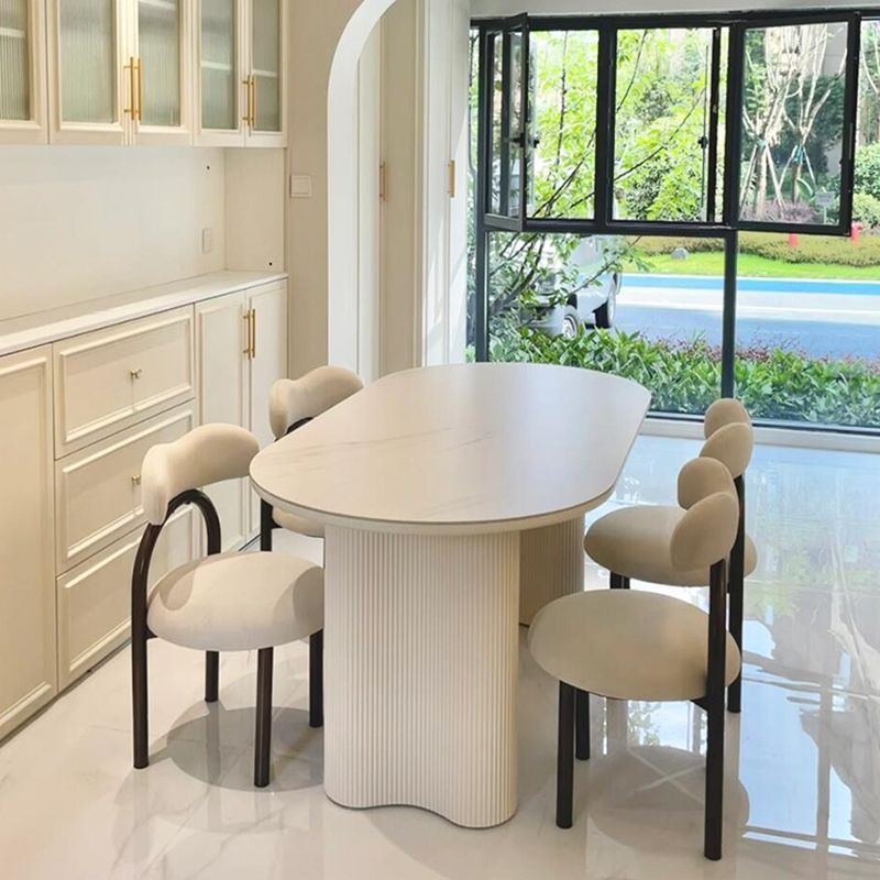 Mesa de comedor ovalada de roca francesa lujosa crema de lujo ligera de alta gama moderna y simple columna de cacahuete silla de viento silencioso combinación de mesa de comedor