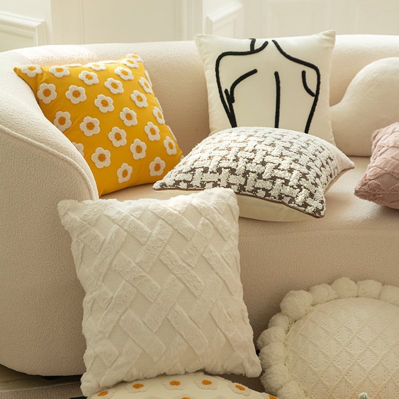 Cream white pillow, plush sofa for bed