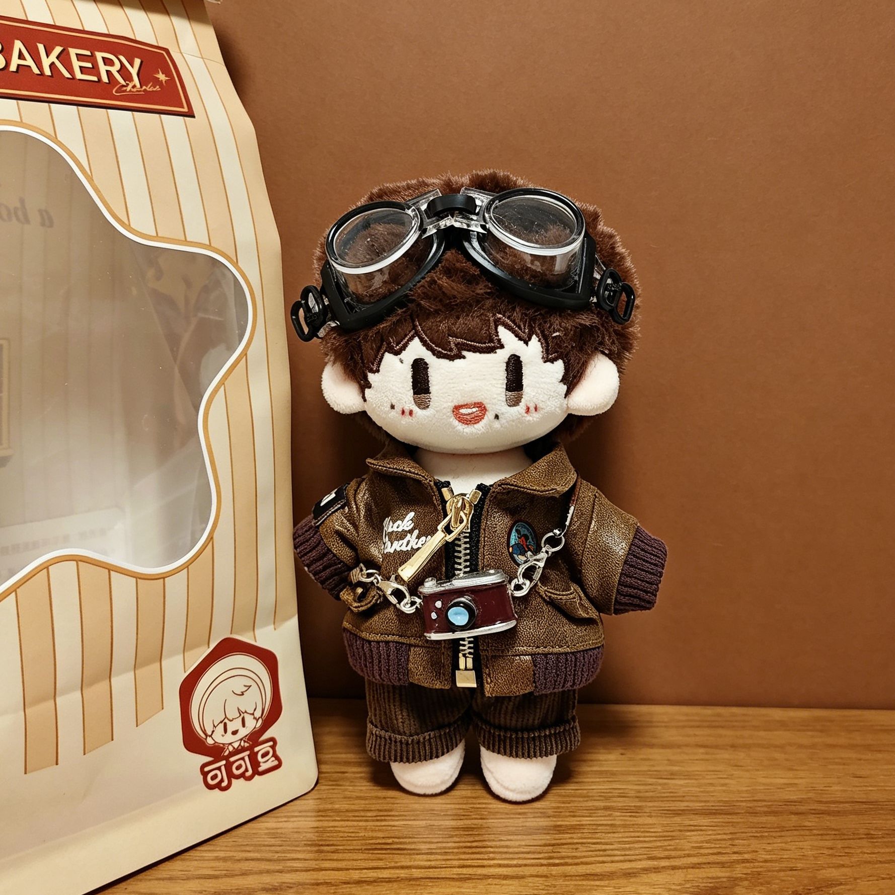 Leather jacket + British shirt + brown pants + camera + goggles