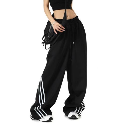 Stylish striped black wide-leg sweatpants for women—spring, American retro-inspired, casual, loose-fitting, and elegantly draping to the floor, trendy design