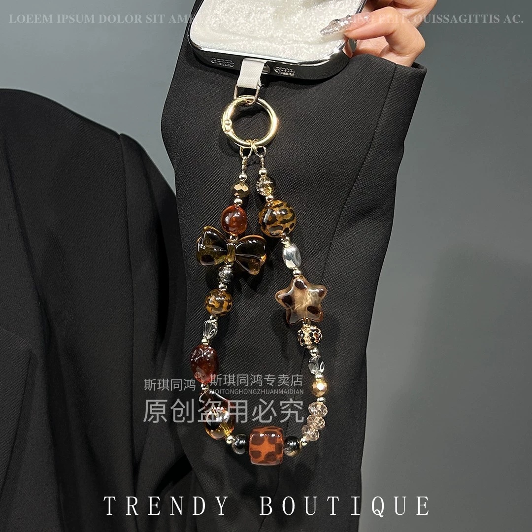 Mobile phone with bow, strap, sophisticated bracelet, pendant