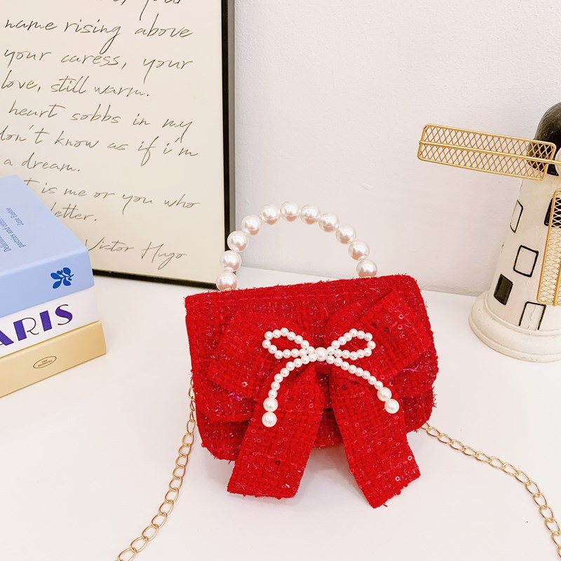 Nuevo bolso de hombro de niñas lindo arco bolso de perla bebé 2025 bolso rojo pequeño viento perfumado bolso para niños