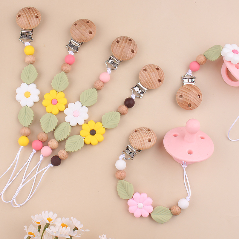 Nuevos productos para bebés Clip de chupete de haya Creativo bebé Silicona margarita mordida molar cadena de chupete anti-caída
