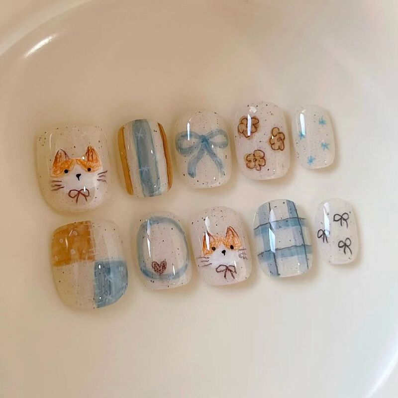 Hand-painted pastoral kitten nail art with blue plaid, bow, and floral short nails, cute and beautiful fake nail patches for cross-border wholesale Hand-painted pastoral kitten nail art with blue plaid, bow, and floral short nails, cute and beautiful fake nail patches for cross-border wholesale
