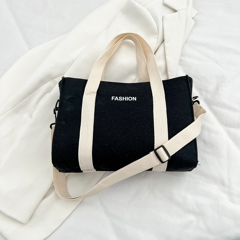 2024 nuevo simple japonés blanco y negro bolso de tela de gran capacidad para estudiantes de clase de viaje mochila de hombro