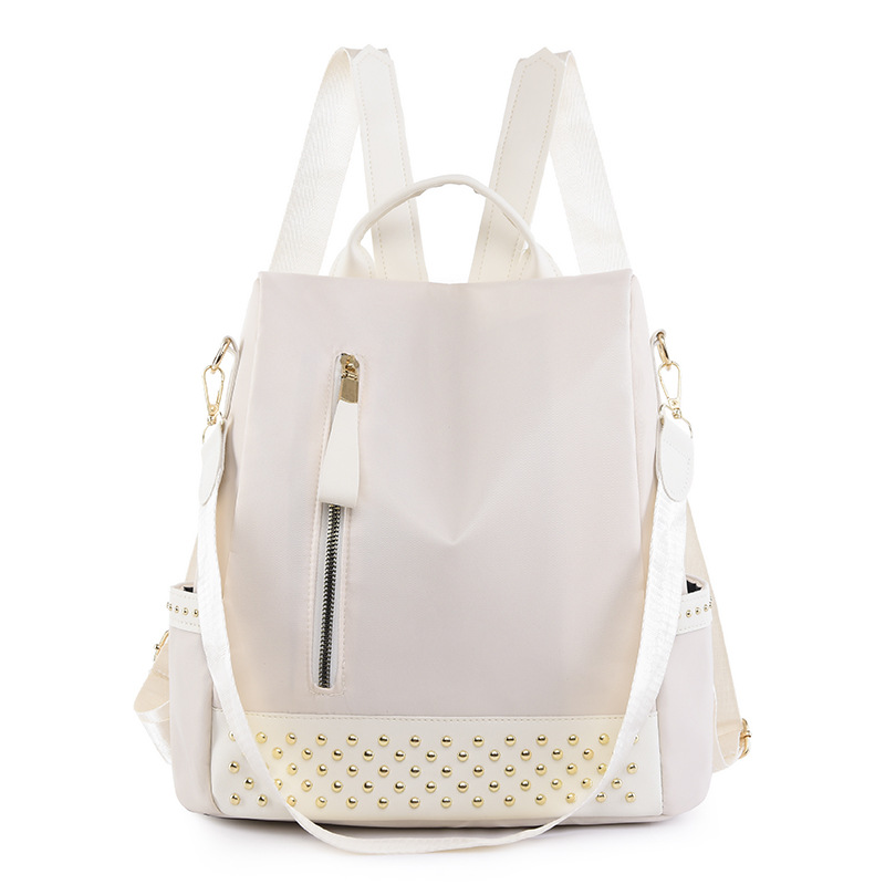 Venta al por mayor 2023 nuevo estilo casual mochila antirrobo mujer simple moda Oxford tela remache mochila escolar de doble uso