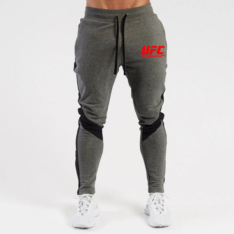 Otoño e invierno letras deportivas juventud ordinaria media elástica Mediados de cintura pantalones de algodón negro en stock moda de lana pantalones de los hombres