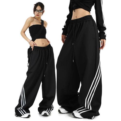 Stylish striped black wide-leg sweatpants for women—spring, American retro-inspired, casual, loose-fitting, and elegantly draping to the floor, trendy design
