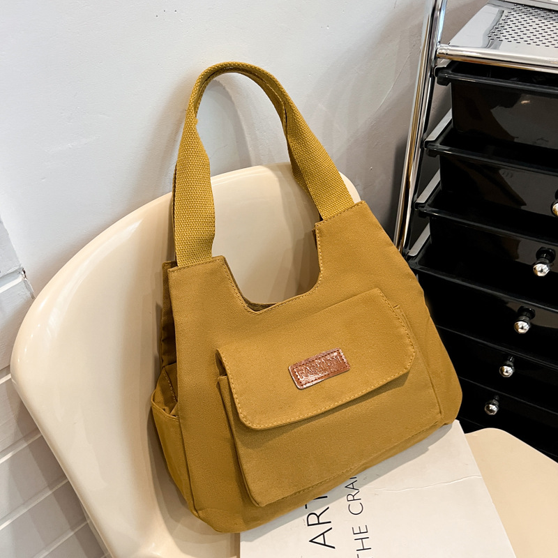 2024 invierno nuevo paquete de viaje japonés retro nicho sensación de diseño bolso de lona simple color sólido bolso casual