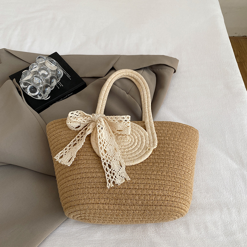 Bolsa de moda de color contrastante portátil de tejido de mujer 2025 tendencia primavera nuevo retro versátil arco bolso de cubo de mano