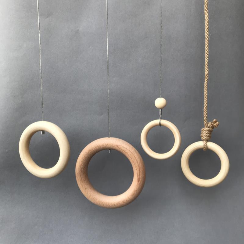 Clothing store hanging hook wall display rack with wire rope clothes rings for displaying children's and women's clothing.