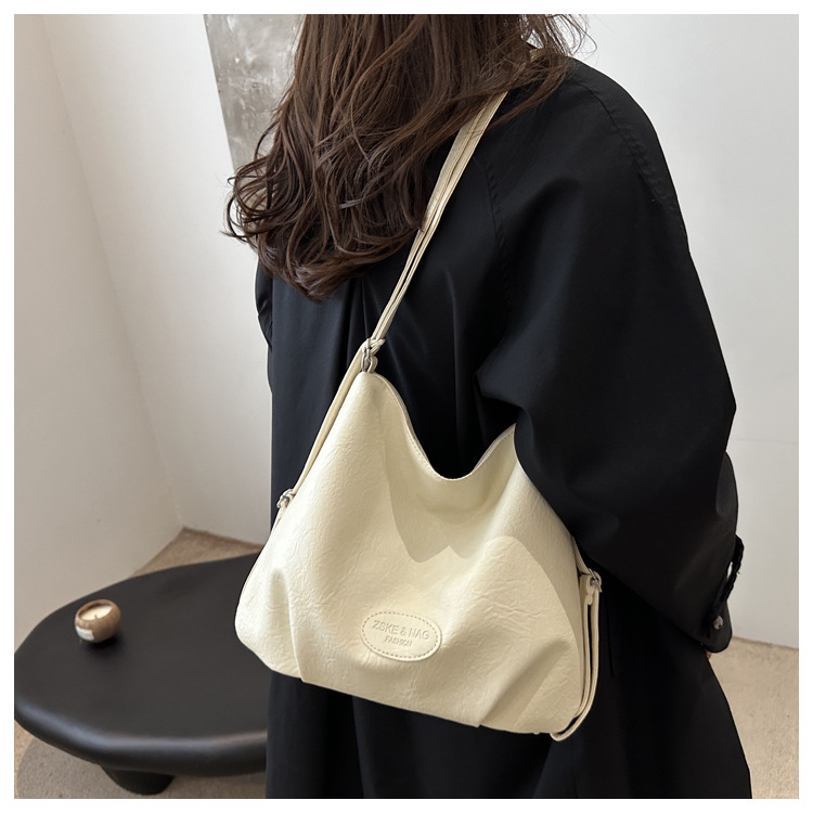 The 2024 new pleated tote bag is a large-capacity casual and fashionable backpack for women, featuring multi-functional texture and a single-shoulder crossbody bag undefined