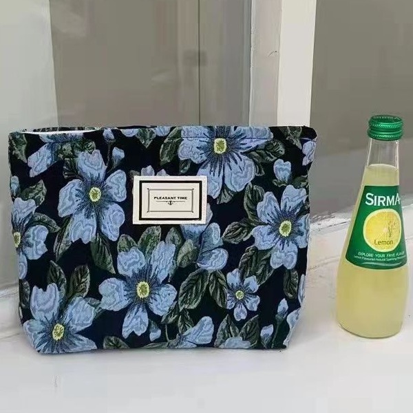 Diseño original de nicho blanco y negro temperamento Jacquard lienzo maquillaje bolsas de mano estilo retro simple flores convenientes